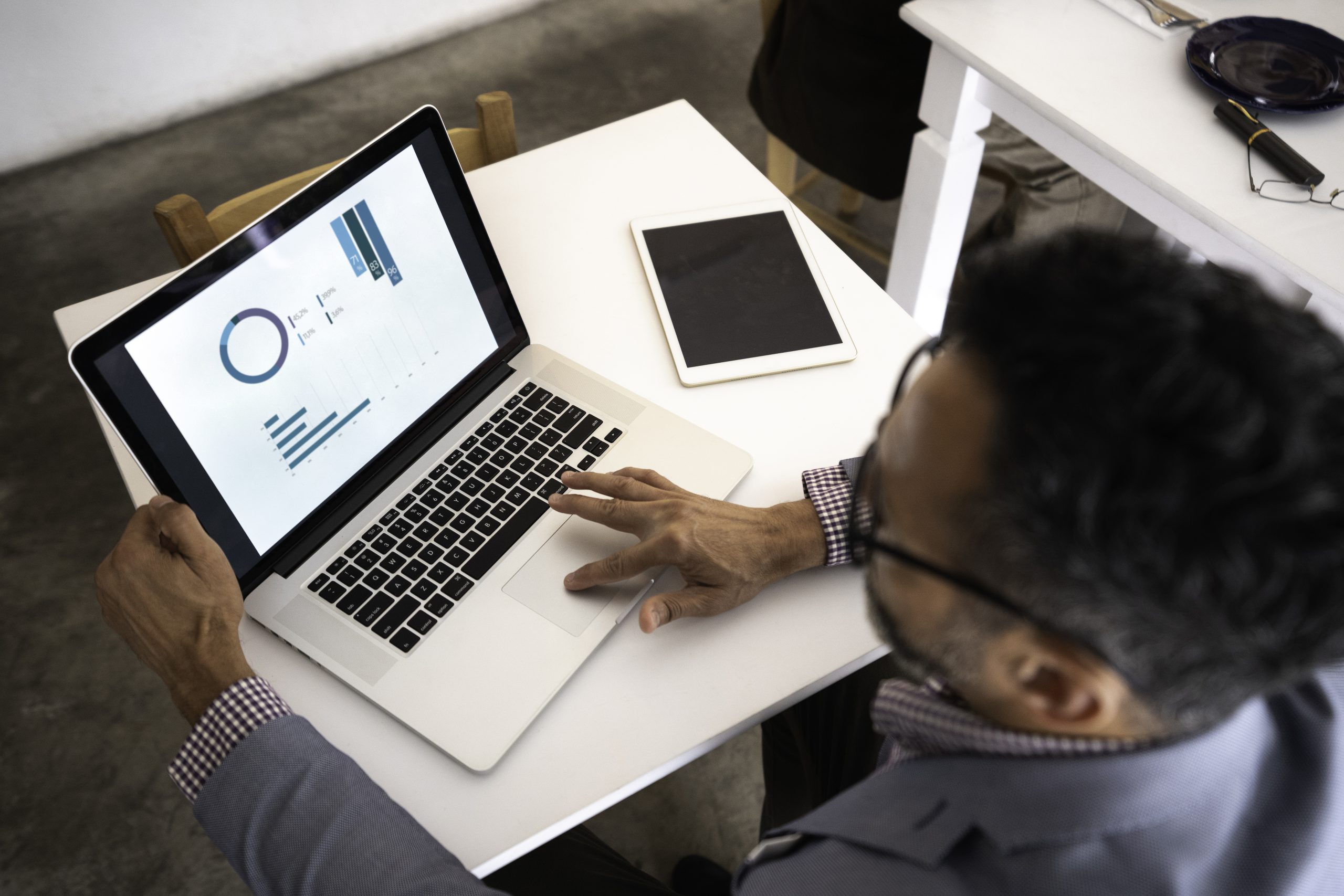 High angle view of a businessman using laptop in a restaurant High angle view of a businessman using laptop in a restaurant